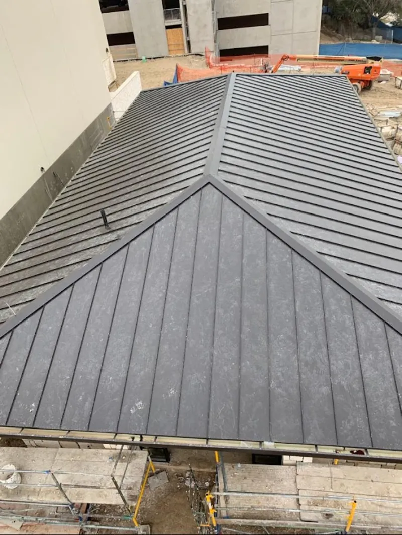 Commercial metal roof construction with crane equipment in Ladera Ranch