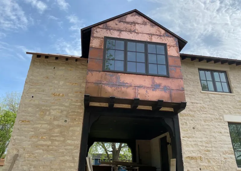 Copper metal panel facade on a stone building for Skylight Installation in Ladera Ranch